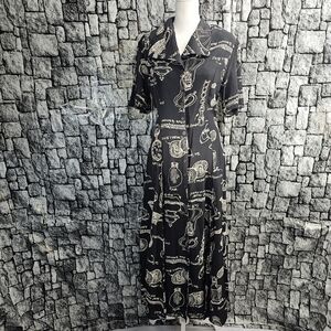 Traditional trading co. Black dress with antique items drawn and labeled. Medium